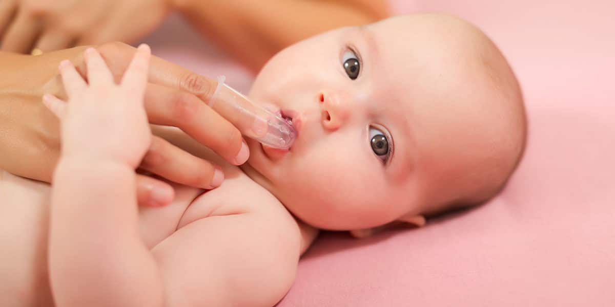 Parent brushing infant's teeth